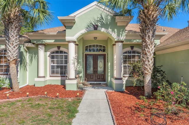 16340 Marquis Rd, Brooksville, FL 34614 - entrance to property with stucco siding, french doors, and a shingled roof