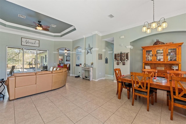 16340 Marquis Rd, Brooksville, FL 34614 - dining space with a raised ceiling, light tile patterned flooring, ceiling fan with notable chandelier, and ornamental molding