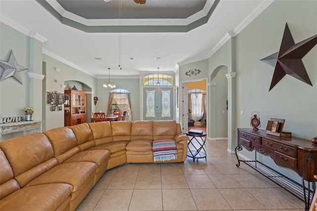 16340 Marquis Rd, Brooksville, FL 34614 - living area with arched walkways, decorative columns, a tray ceiling, and light tile patterned flooring