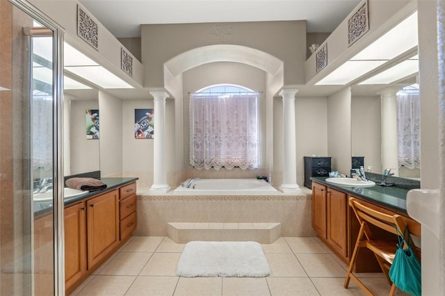 16340 Marquis Rd, Brooksville, FL 34614 - bathroom featuring vanity, tile patterned floors, decorative columns, and a garden tub