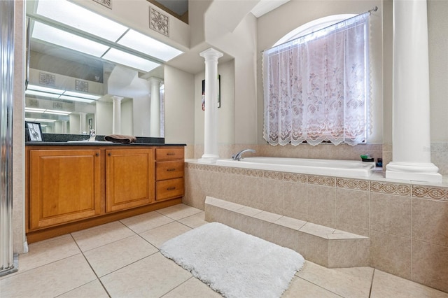 16340 Marquis Rd, Brooksville, FL 34614 - bathroom with tile patterned floors, decorative columns, a bath, and vanity