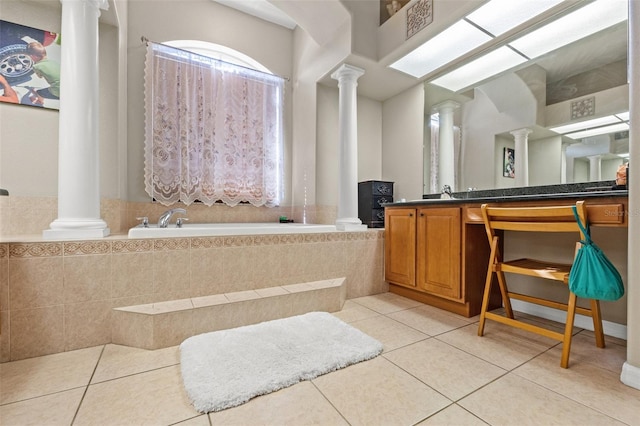 16340 Marquis Rd, Brooksville, FL 34614 - full bath featuring tile patterned flooring, toilet, a bath, vanity, and ornate columns