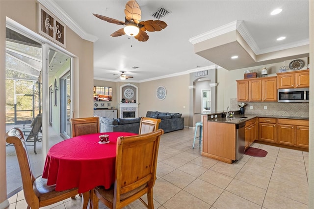 16340 Marquis Rd, Brooksville, FL 34614 - dining space with light tile patterned floors, visible vents, ceiling fan, and ornamental molding