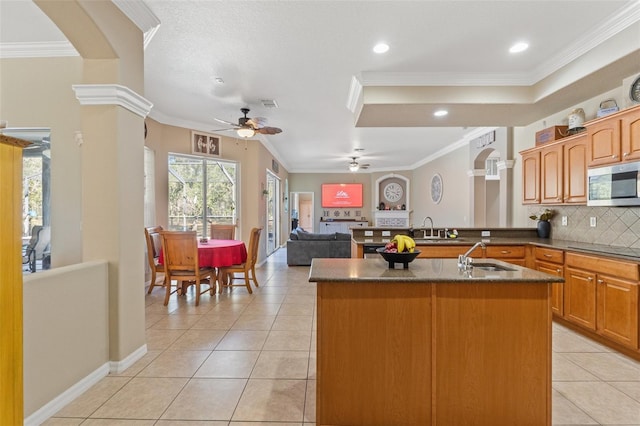 16340 Marquis Rd, Brooksville, FL 34614 - kitchen featuring stainless steel microwave, ornamental molding, ceiling fan, and a sink