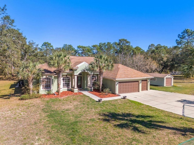 16340 Marquis Rd, Brooksville, FL 34614 - mediterranean / spanish house with stucco siding, an attached garage, driveway, and a front lawn