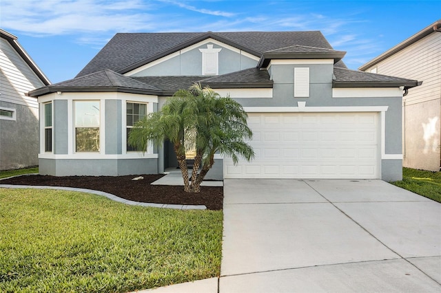 7494 Pool Compass Loop, Wesley Chapel, FL 33545 - view of front facade featuring stucco siding, a garage, driveway, and a front yard