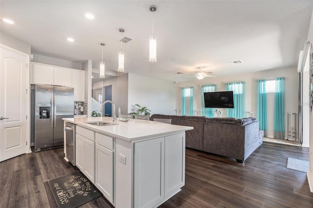 7494 Pool Compass Loop, Wesley Chapel, FL 33545 - kitchen with stainless steel appliances, a sink, a ceiling fan, white cabinets, and dark wood-style flooring
