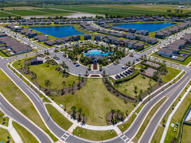birds eye view of property with a residential view and a water view