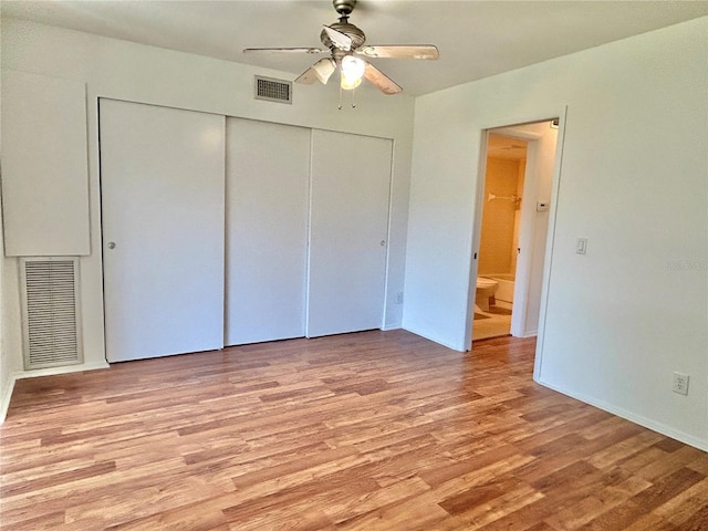 unfurnished bedroom featuring a closet, visible vents, light wood-style flooring, and a ceiling fan