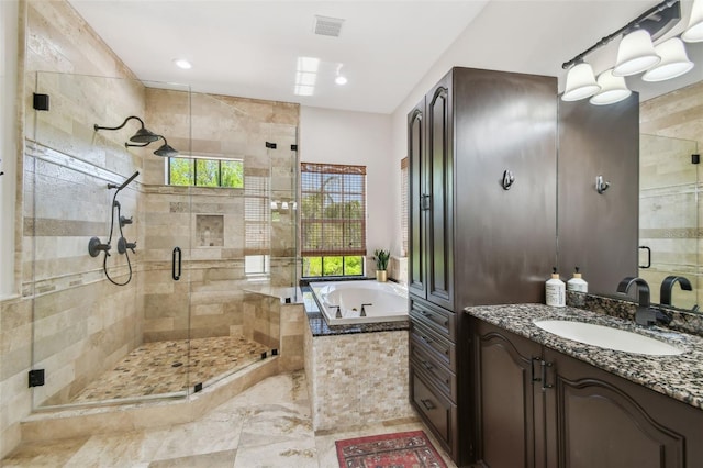 full bath with a garden tub, visible vents, a wealth of natural light, and a stall shower