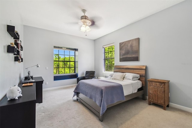 carpeted bedroom featuring a ceiling fan and baseboards