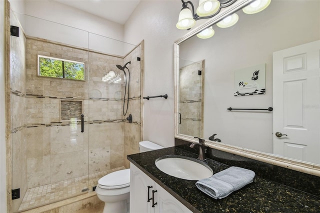 full bath with vanity, toilet, and a shower stall