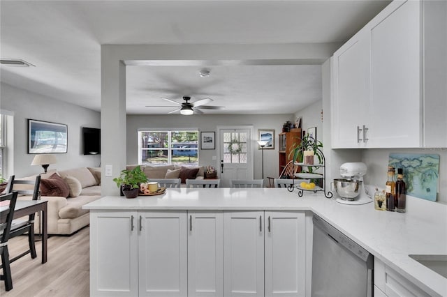 kitchen with white cabinetry, open floor plan, dishwasher, a peninsula, and a ceiling fan