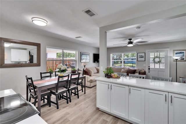 kitchen with visible vents, ceiling fan, open floor plan, and plenty of natural light
