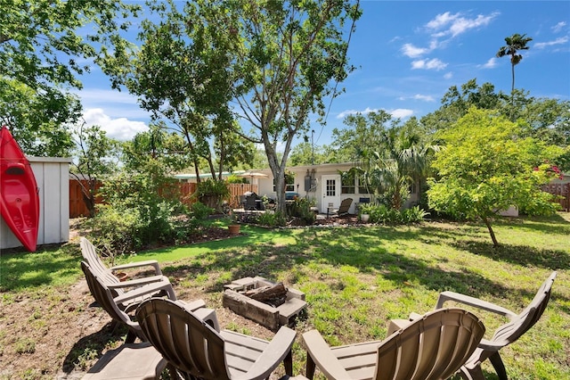 view of yard with a fire pit and a fenced backyard