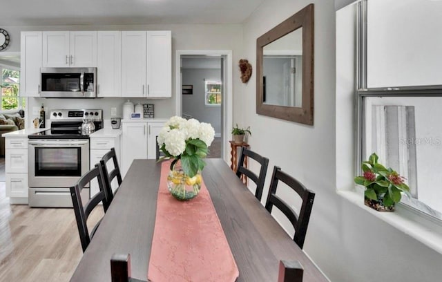 dining space featuring light wood-type flooring