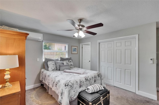 bedroom with a textured ceiling, a closet, baseboards, light carpet, and a ceiling fan