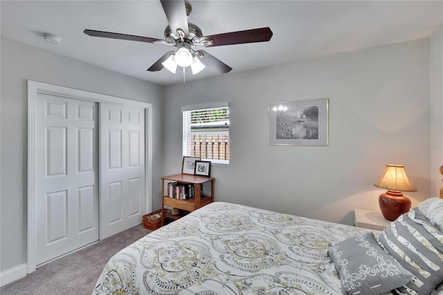 carpeted bedroom featuring a closet and a ceiling fan