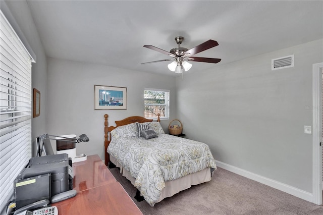 carpeted bedroom with visible vents, ceiling fan, and baseboards