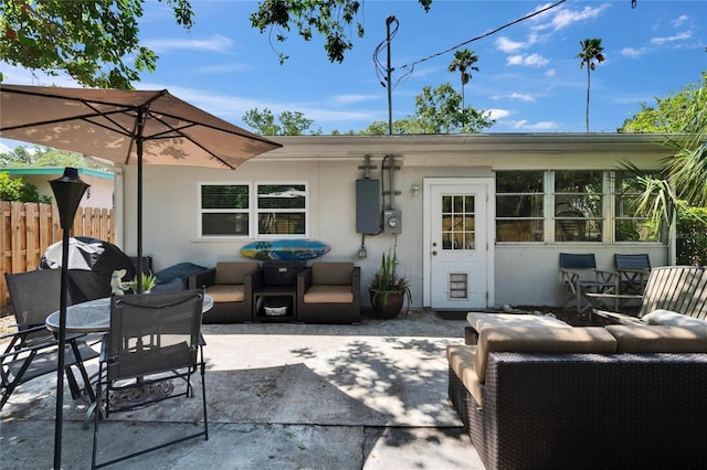 rear view of house featuring an outdoor living space, outdoor dining space, and a patio area