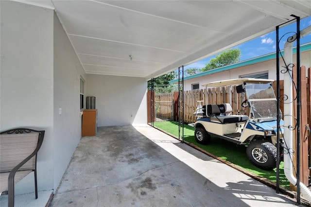 view of patio / terrace featuring fence and an attached carport