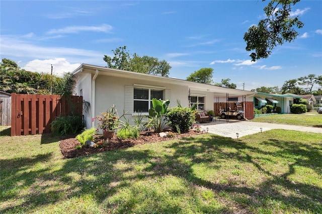 ranch-style house with a patio, fence, stucco siding, and a front yard