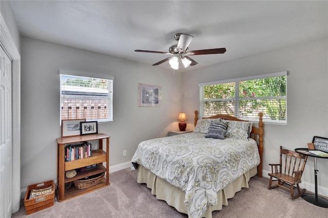 carpeted bedroom with baseboards, a ceiling fan, and a closet