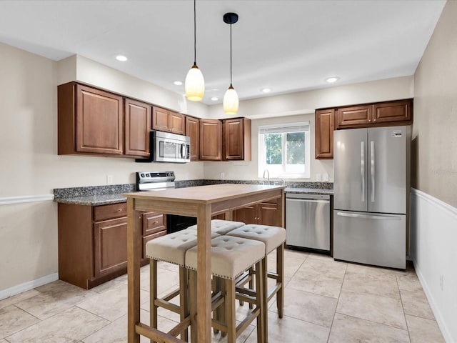 4500 23rd Ave S, Saint Petersburg, FL 33711 - kitchen with a sink, brown cabinetry, decorative light fixtures, appliances with stainless steel finishes, and recessed lighting