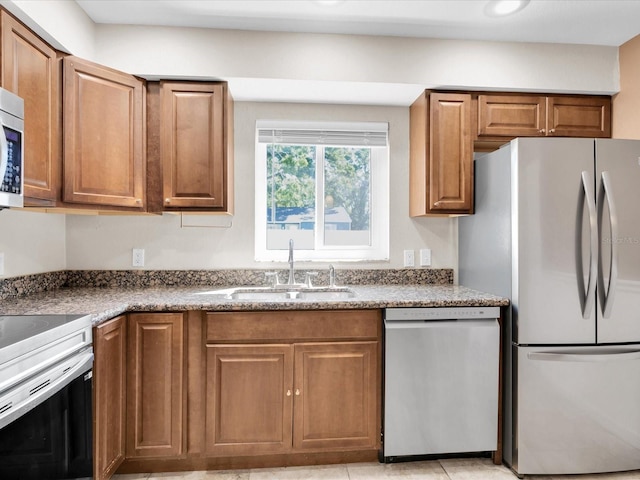 4500 23rd Ave S, Saint Petersburg, FL 33711 - kitchen featuring brown cabinetry, appliances with stainless steel finishes, and a sink