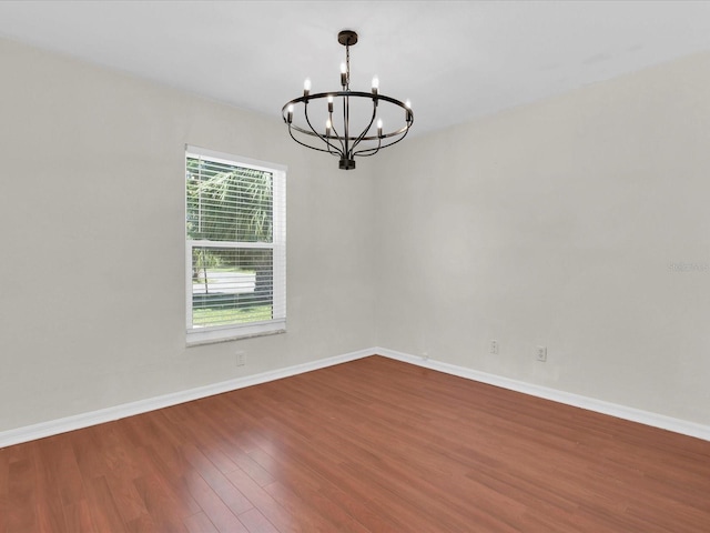 4500 23rd Ave S, Saint Petersburg, FL 33711 - empty room with an inviting chandelier, wood finished floors, and baseboards