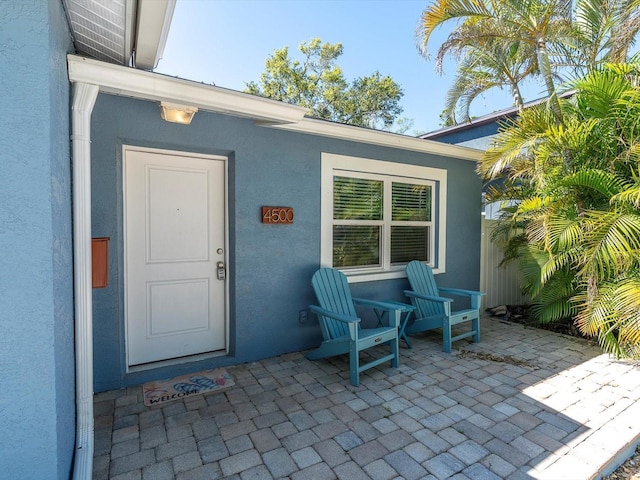 4500 23rd Ave S, Saint Petersburg, FL 33711 - property entrance with fence, a patio, and stucco siding