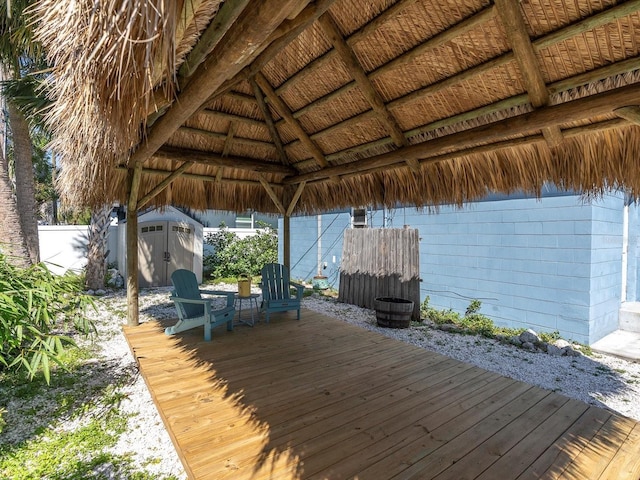 4500 23rd Ave S, Saint Petersburg, FL 33711 - wooden terrace with a gazebo, a storage unit, fence, and an outdoor structure