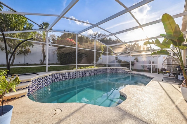 view of pool with a fenced backyard, a patio, a fenced in pool, and glass enclosure
