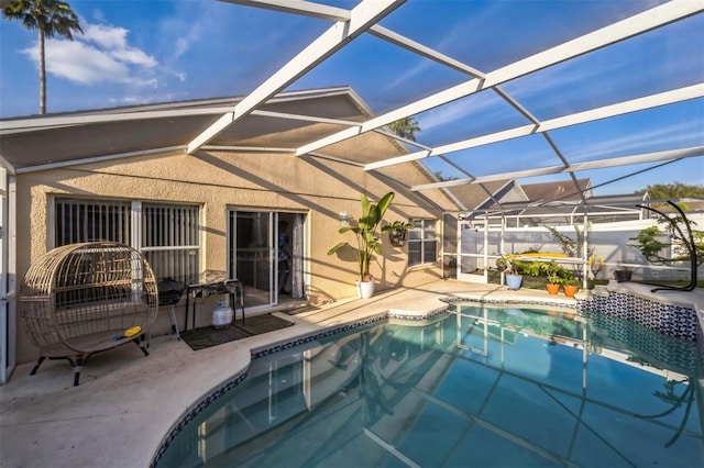 outdoor pool with a patio area and glass enclosure