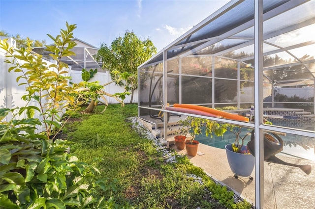 view of yard with a fenced backyard and a lanai