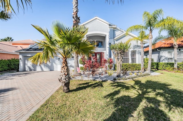 17927 Bahama Isle Cir, Tampa, FL 33647 - view of front of home featuring a front yard, decorative driveway, stucco siding, and a garage