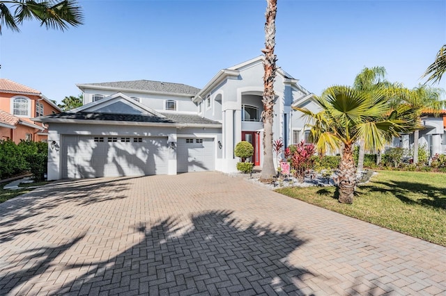 17927 Bahama Isle Cir, Tampa, FL 33647 - traditional home with a front yard, decorative driveway, stucco siding, and a garage