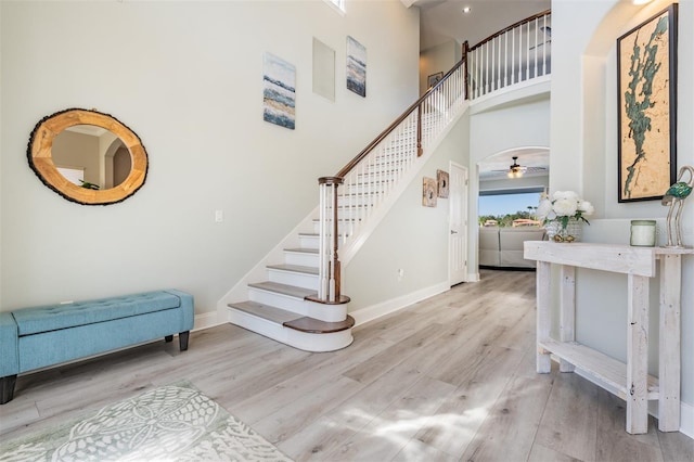 17927 Bahama Isle Cir, Tampa, FL 33647 - stairway with baseboards, wood finished floors, ceiling fan, and a high ceiling