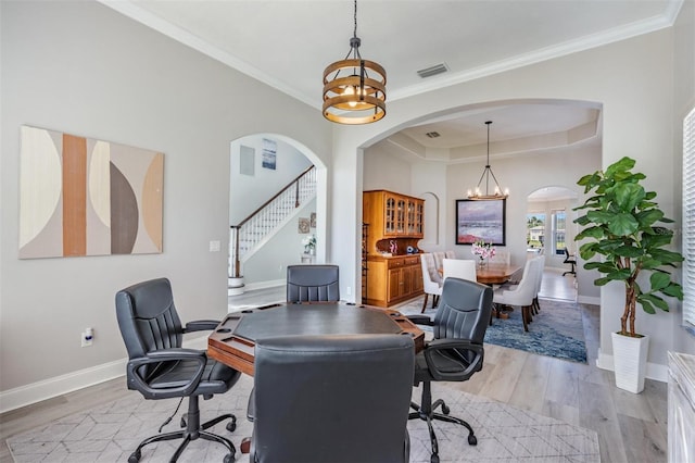 17927 Bahama Isle Cir, Tampa, FL 33647 - office with visible vents, a tray ceiling, light wood-style flooring, and arched walkways