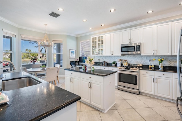 17927 Bahama Isle Cir, Tampa, FL 33647 - kitchen with visible vents, stainless steel appliances, white cabinets, and a sink