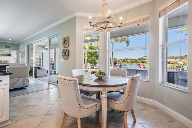 17927 Bahama Isle Cir, Tampa, FL 33647 - dining area featuring light tile patterned floors, crown molding, baseboards, and ceiling fan with notable chandelier