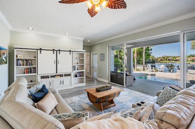17927 Bahama Isle Cir, Tampa, FL 33647 - living area with ceiling fan, crown molding, light wood-style flooring, and baseboards