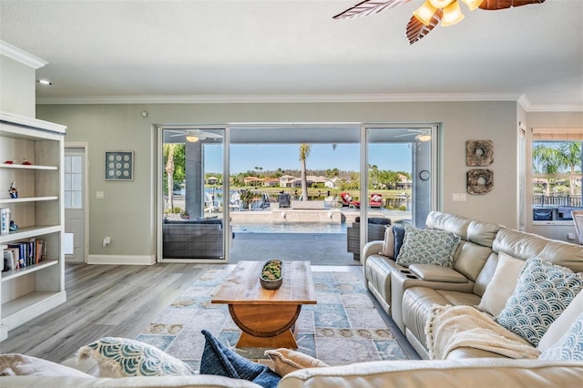 17927 Bahama Isle Cir, Tampa, FL 33647 - living room featuring baseboards, ornamental molding, ceiling fan, and wood finished floors