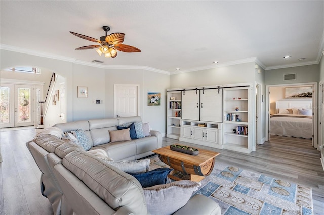 17927 Bahama Isle Cir, Tampa, FL 33647 - living room with recessed lighting, arched walkways, ceiling fan, and light wood-style flooring