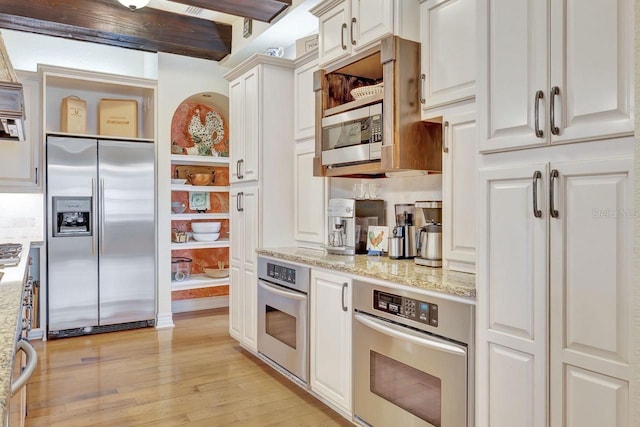 kitchen featuring stainless steel appliances, light wood-type flooring, white cabinetry, light stone countertops, and open shelves