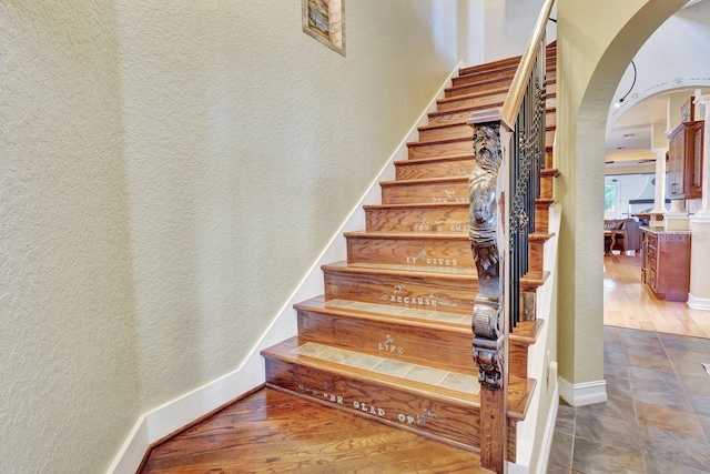 1108 W Charter St, Tampa, FL 33602 - stairway with arched walkways, wood finished floors, and baseboards