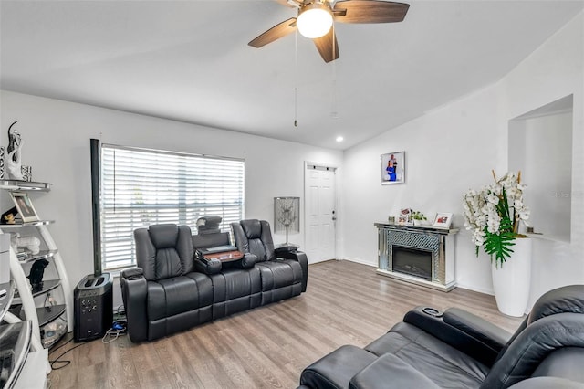 8528 Quarter Horse Dr, Riverview, FL 33578 - living area featuring a ceiling fan, wood finished floors, a glass covered fireplace, lofted ceiling, and recessed lighting
