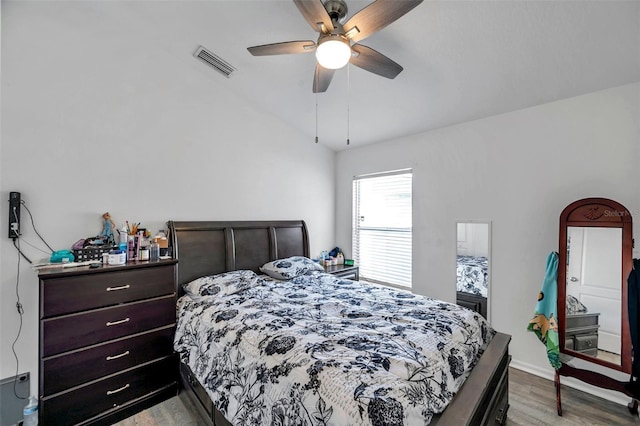 8528 Quarter Horse Dr, Riverview, FL 33578 - bedroom with wood finished floors, vaulted ceiling, and a ceiling fan