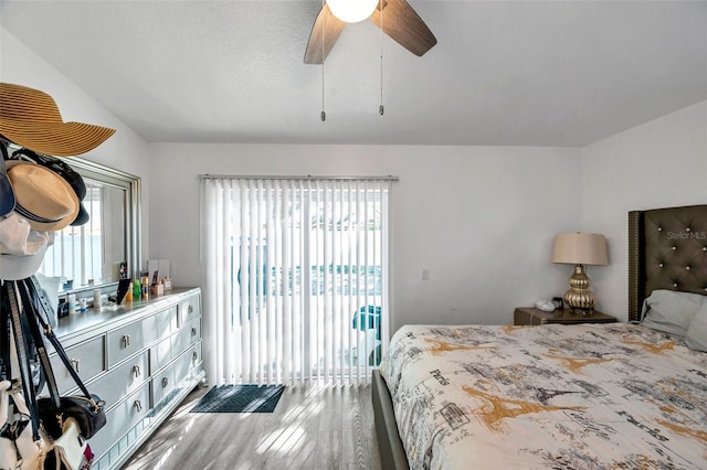 8528 Quarter Horse Dr, Riverview, FL 33578 - bedroom with access to exterior, multiple windows, wood finished floors, lofted ceiling, and a ceiling fan