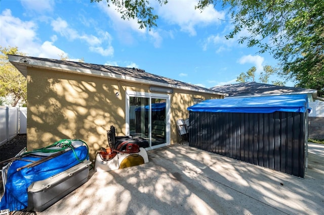 8528 Quarter Horse Dr, Riverview, FL 33578 - rear view of house with a jacuzzi, a patio, and stucco siding